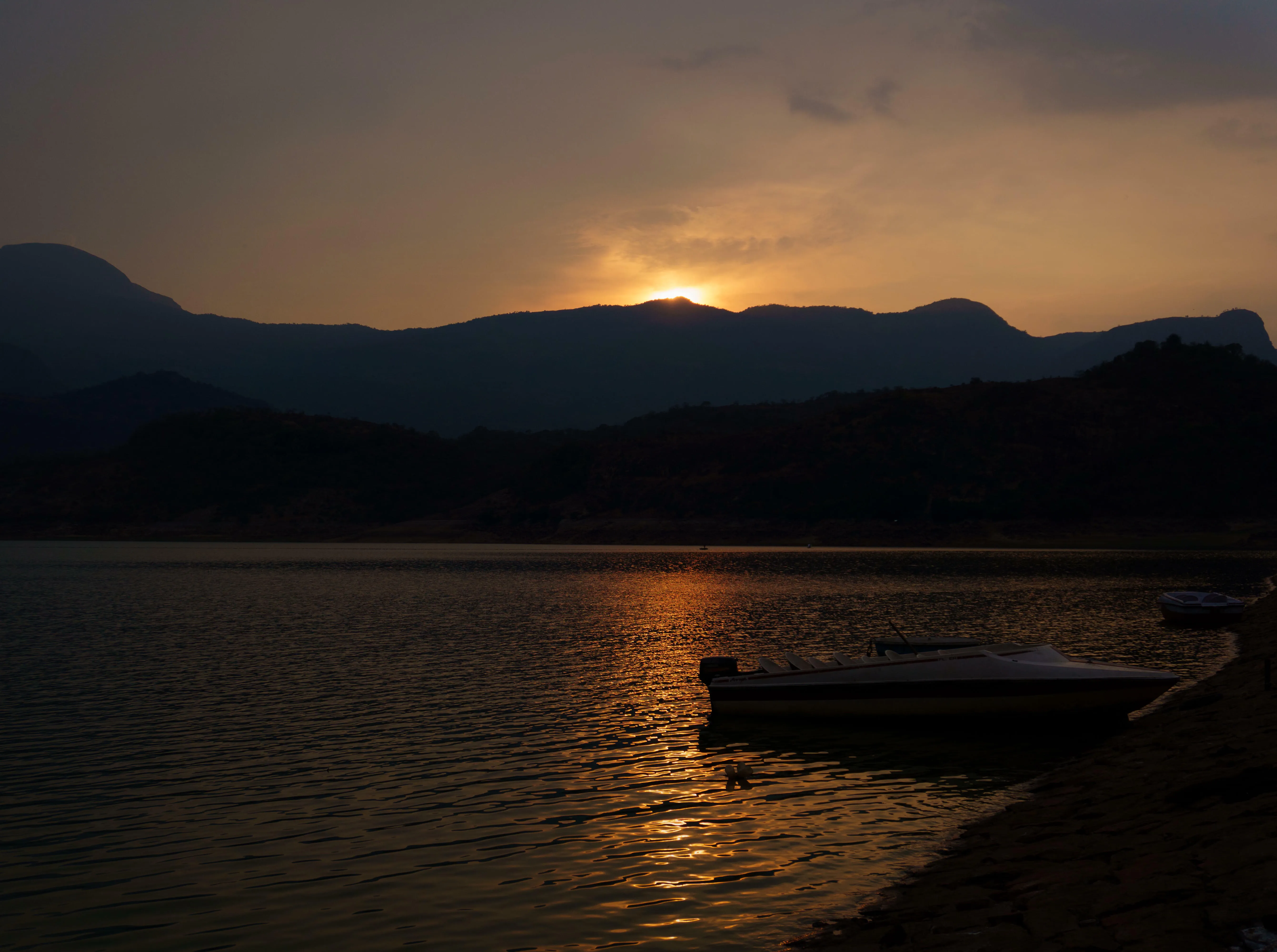 Boat in dam during sunset time